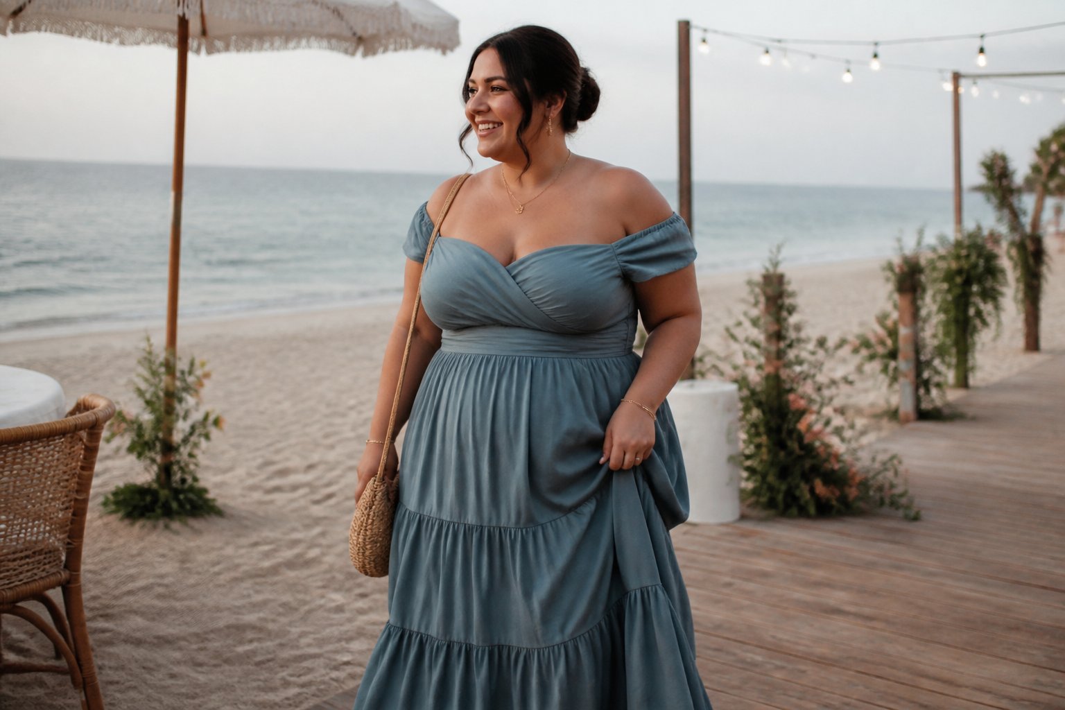 A plus-size woman in an off-shoulder tiered maxi dress walks beside a beach wedding setting.