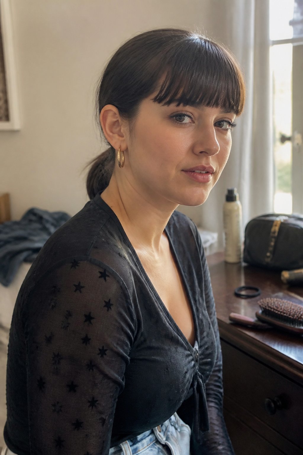 Person wearing a sleek low ponytail with blunt bangs while preparing for a concert.